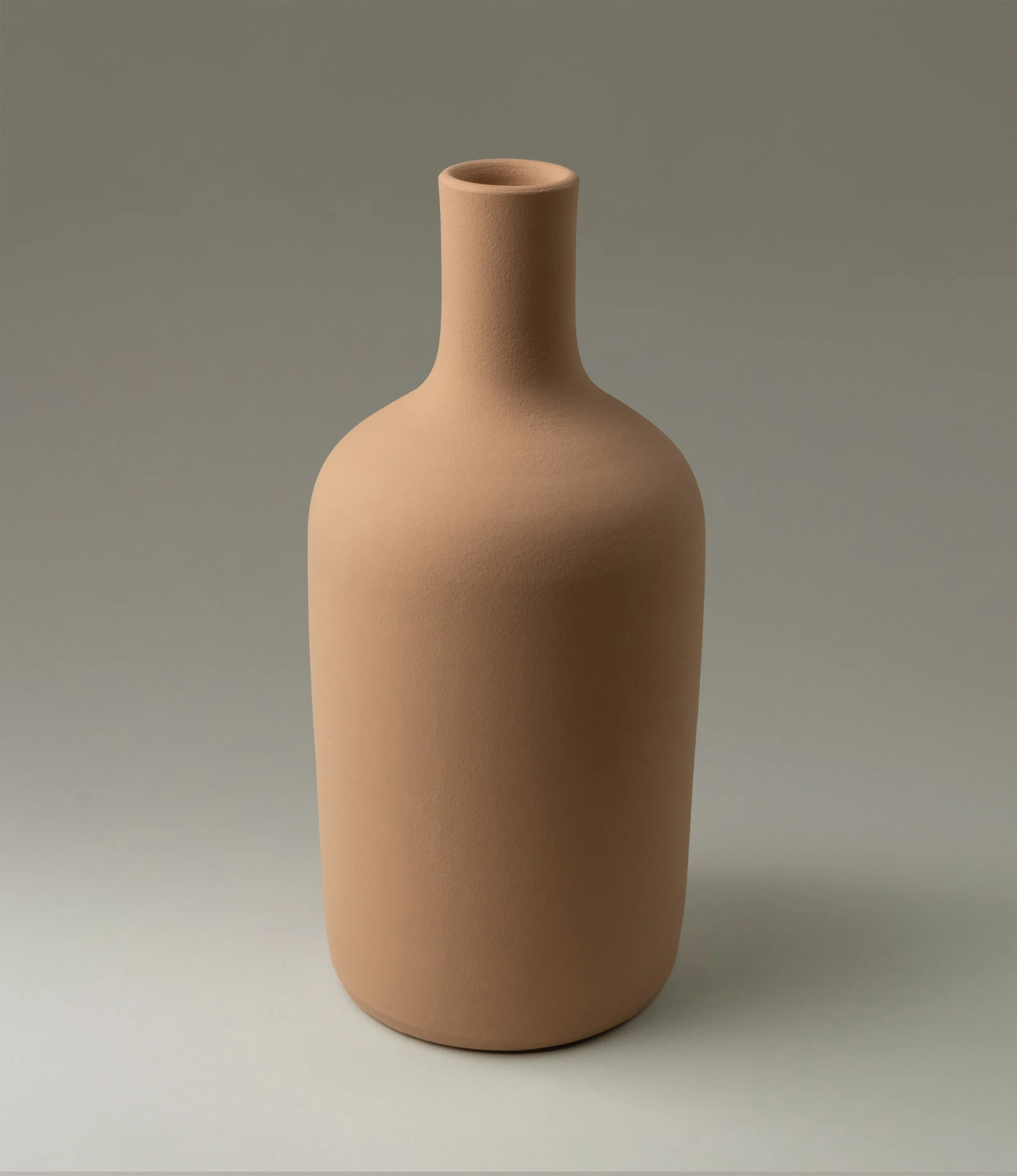 This Beige Vase from Ocactuu has a pure silhouette with a natural beige shade. It is a medium sized vase, perfect for your fresh flowers. The neck of the vase is rather tight thus you can use this piece with only a few branch as well. Perfect choice for a minimalist home, but can balance well other more playful items too.