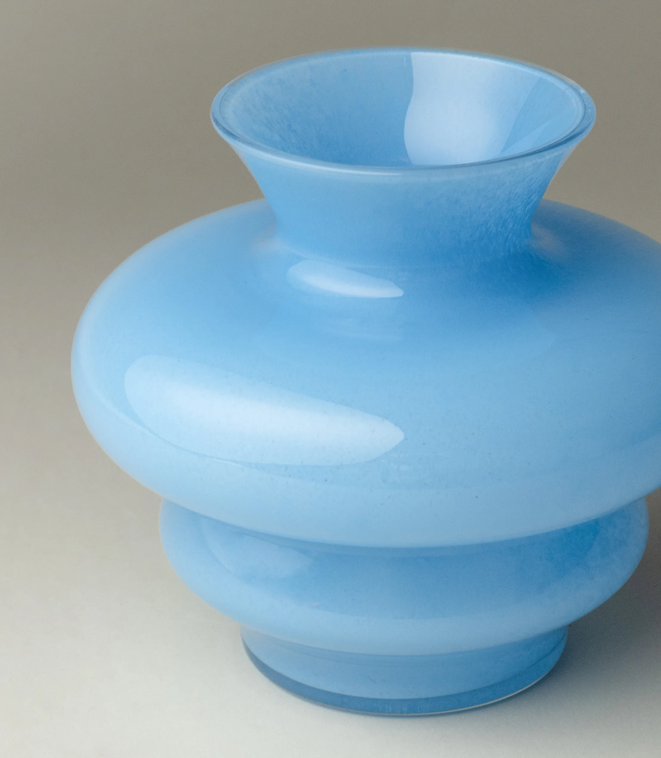 A Closeup of the Blue Curve Mini Vase from Stences. The material of the item is glass