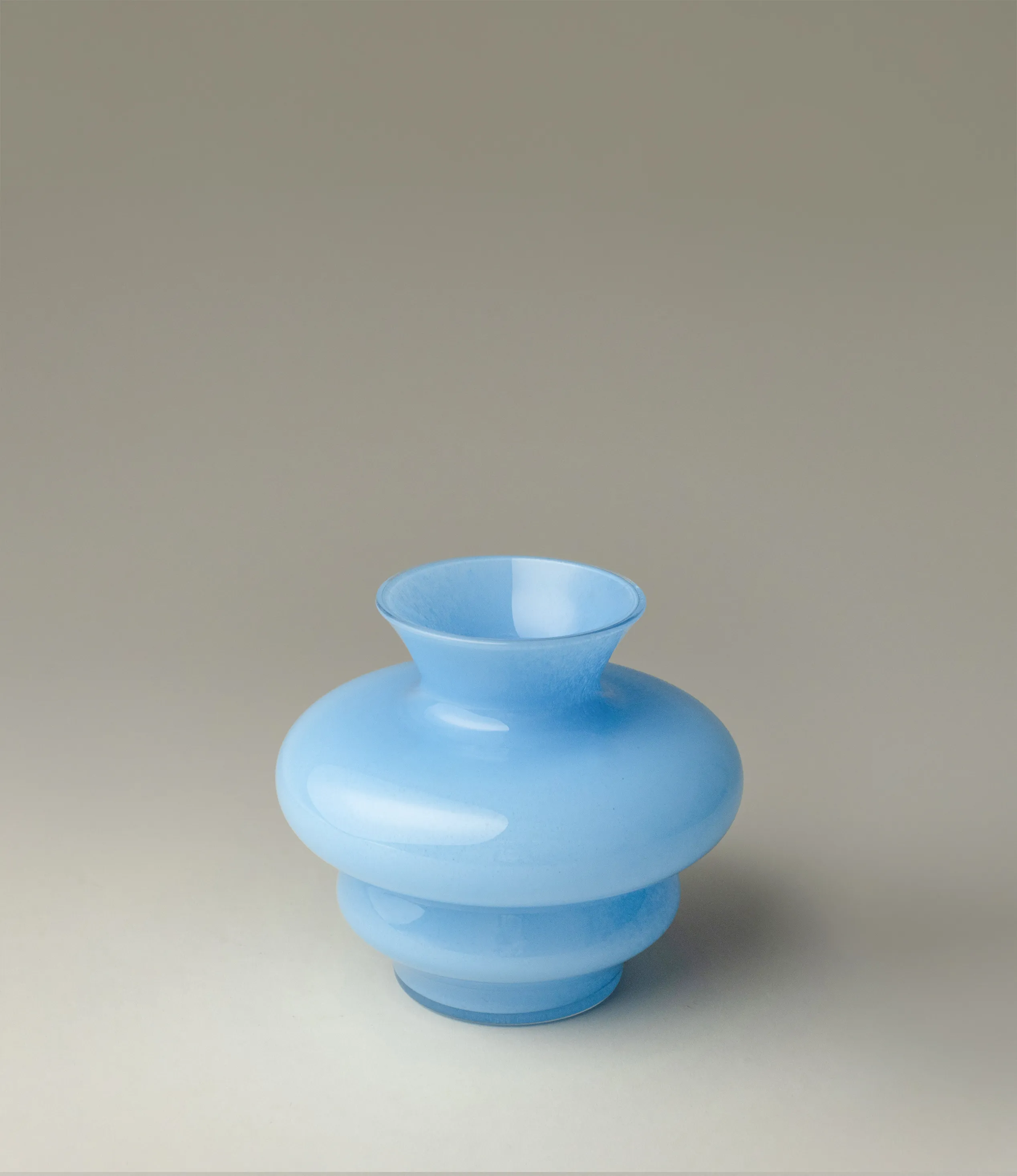 Wave Vase Mini from Stences comes in a Blue color. It is a cury glass vase, which makes your interior pop.