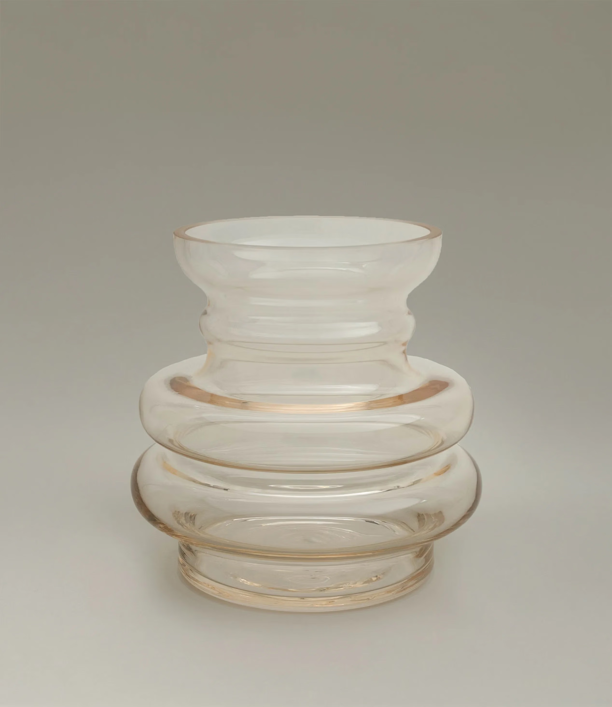 Curve Vase Gul from Stences is a glass vase which has a hint of beige color on it. Still very transparent and glossy.