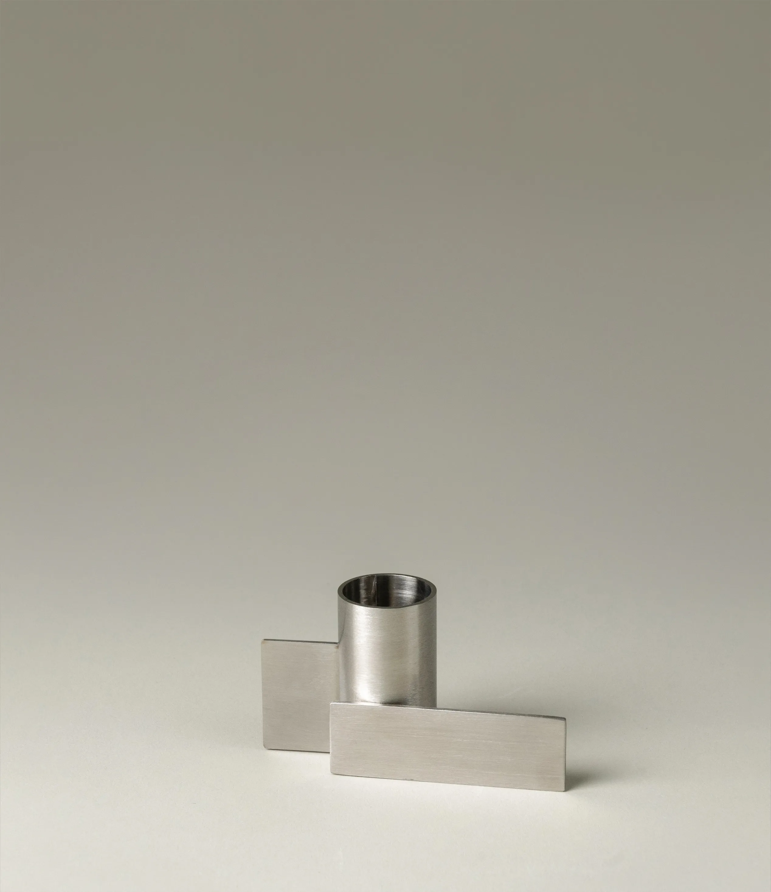 Icon Iysestage 01 from Stences is a candleholder made for taper candles. This picture shows the chrome variant of this item. The steel material has a glossy surface which emphasize the soft geometric shapes of the product in question.