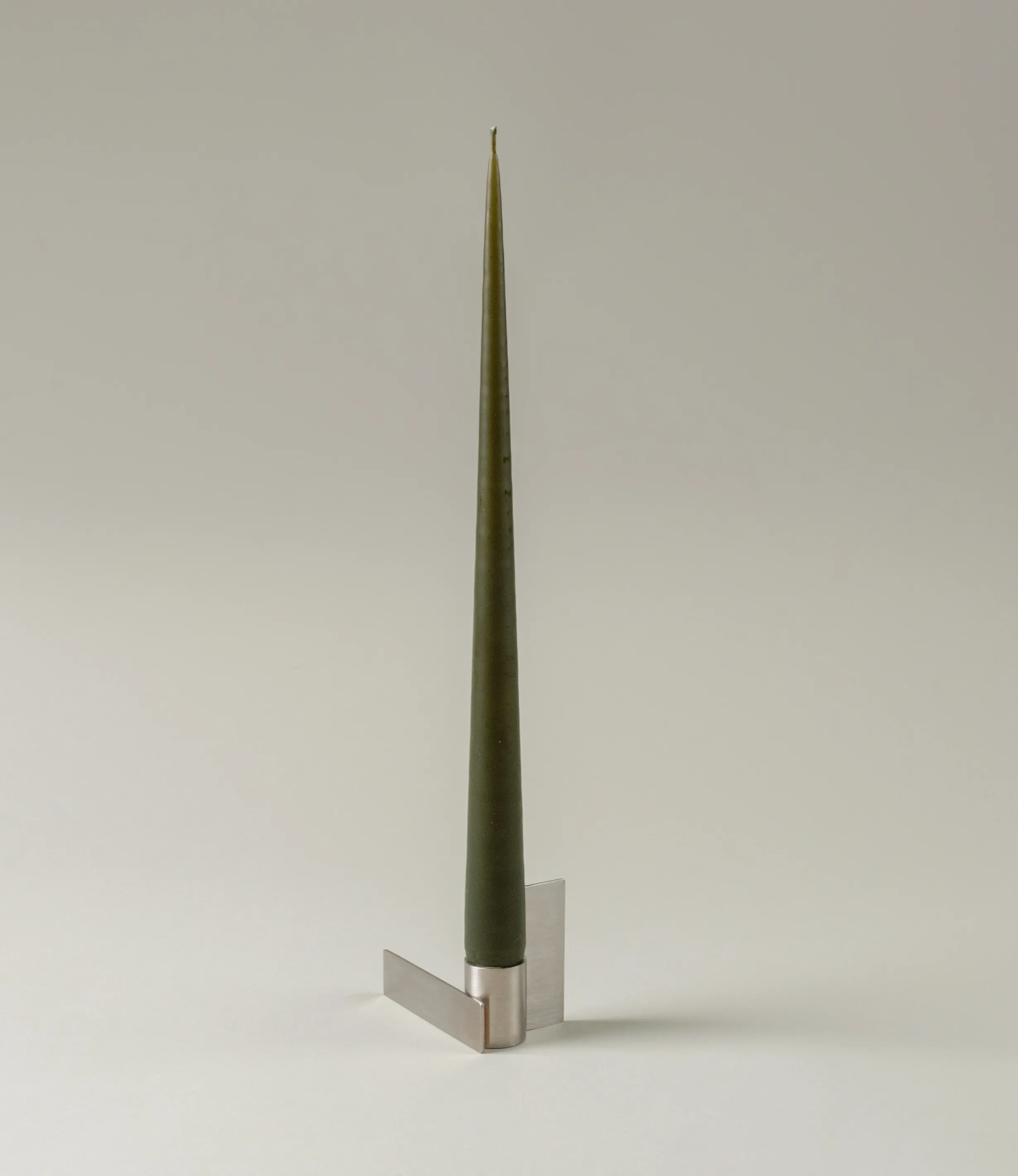 Ester&Erik's Taper Candle coming in the hue of Deep Forest. This dark warm green shade fits perfectly with the light stainless steel material of Icon Candleholder from Stences