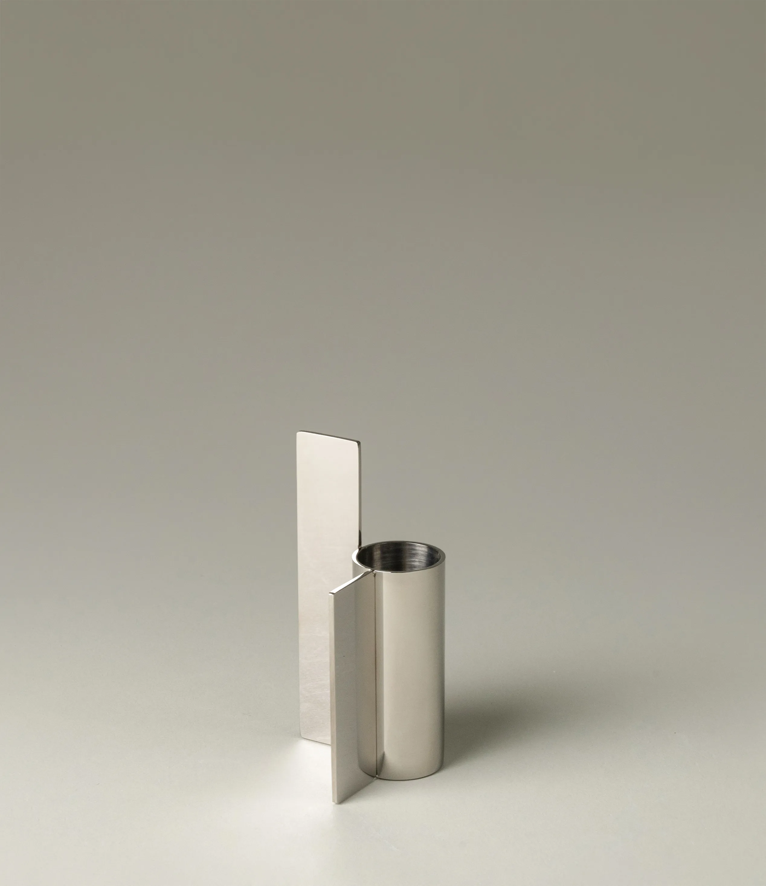 Icon Iysestage 03 from Stences is a candleholder made for taper candles. This picture shows the chrome variant of this item. The steel material has a glossy surface which emphasize the soft geometric shapes of the product in question.