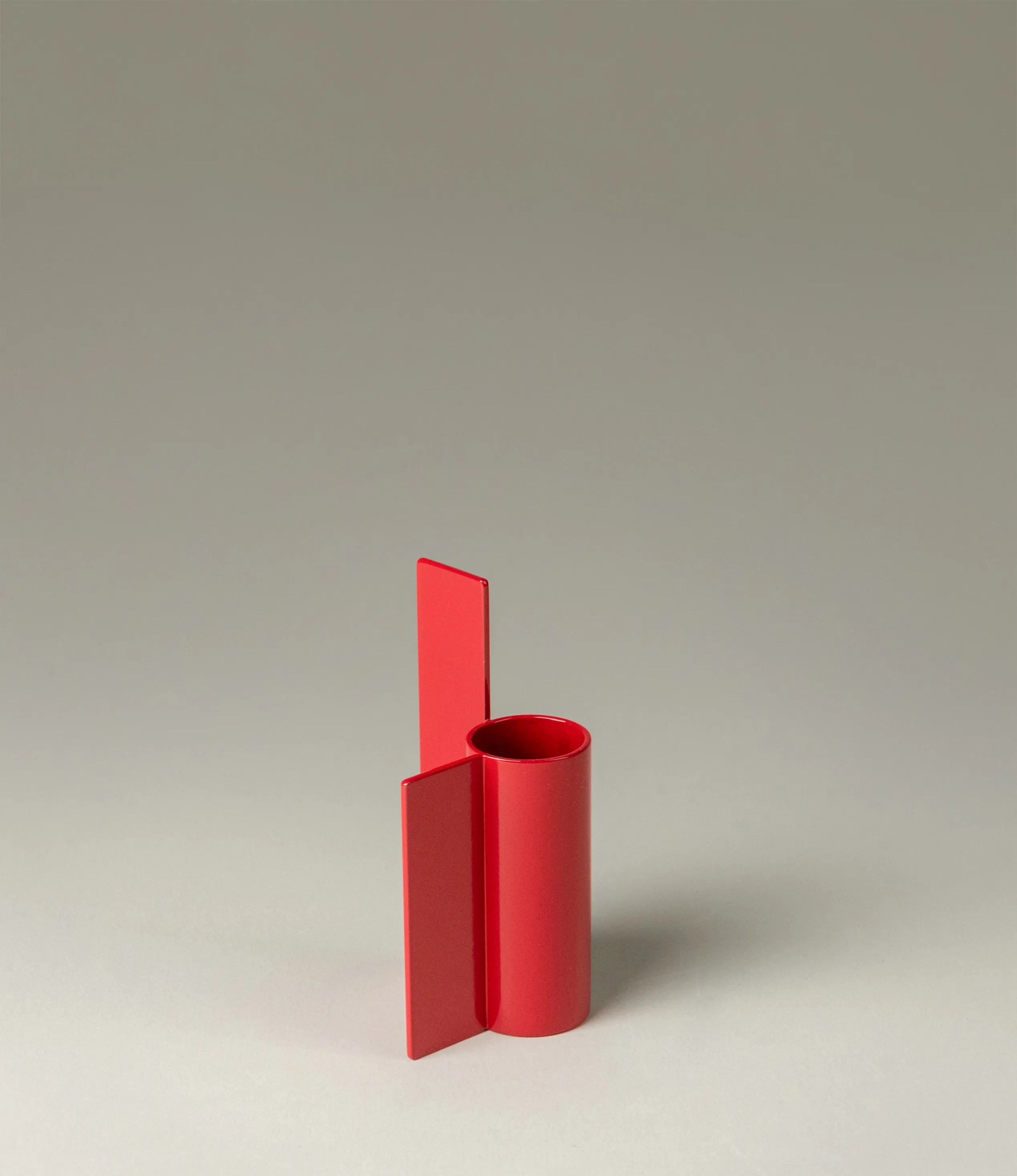 Icon Iysestage 03 from Stences is a candleholder made for taper candles. This picture shows the red variant of this item. The steel material has a glossy surface which emphasize the soft geometric shapes of the product in question.