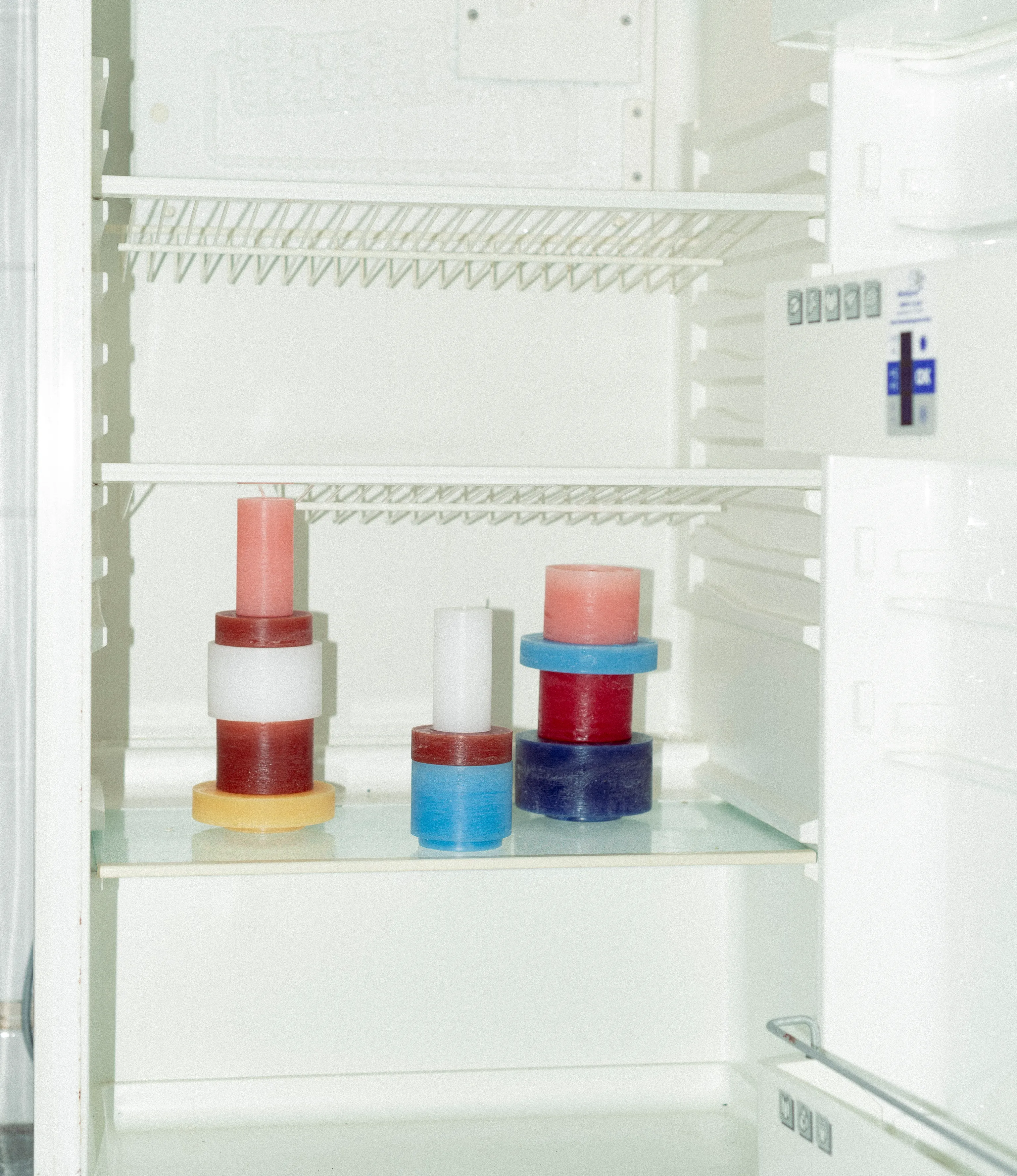 Stackable Candles of Stan Editions showcased in a retro fridge.
